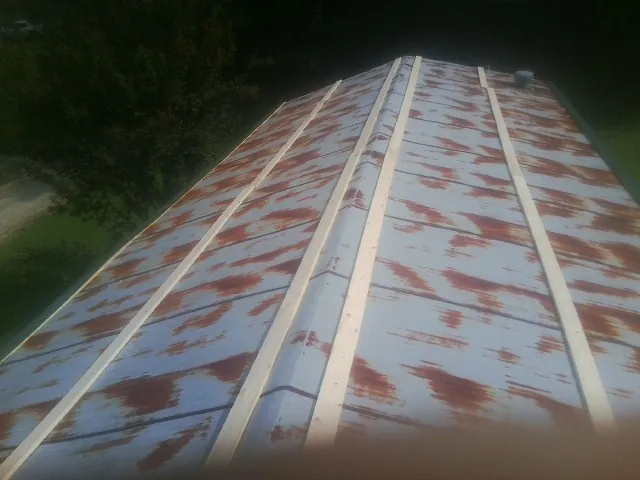 Rusted metal roof panels with new wood purlins before replacement — Storm Damage Roof Repair in Sykesville by Roofing Brothers