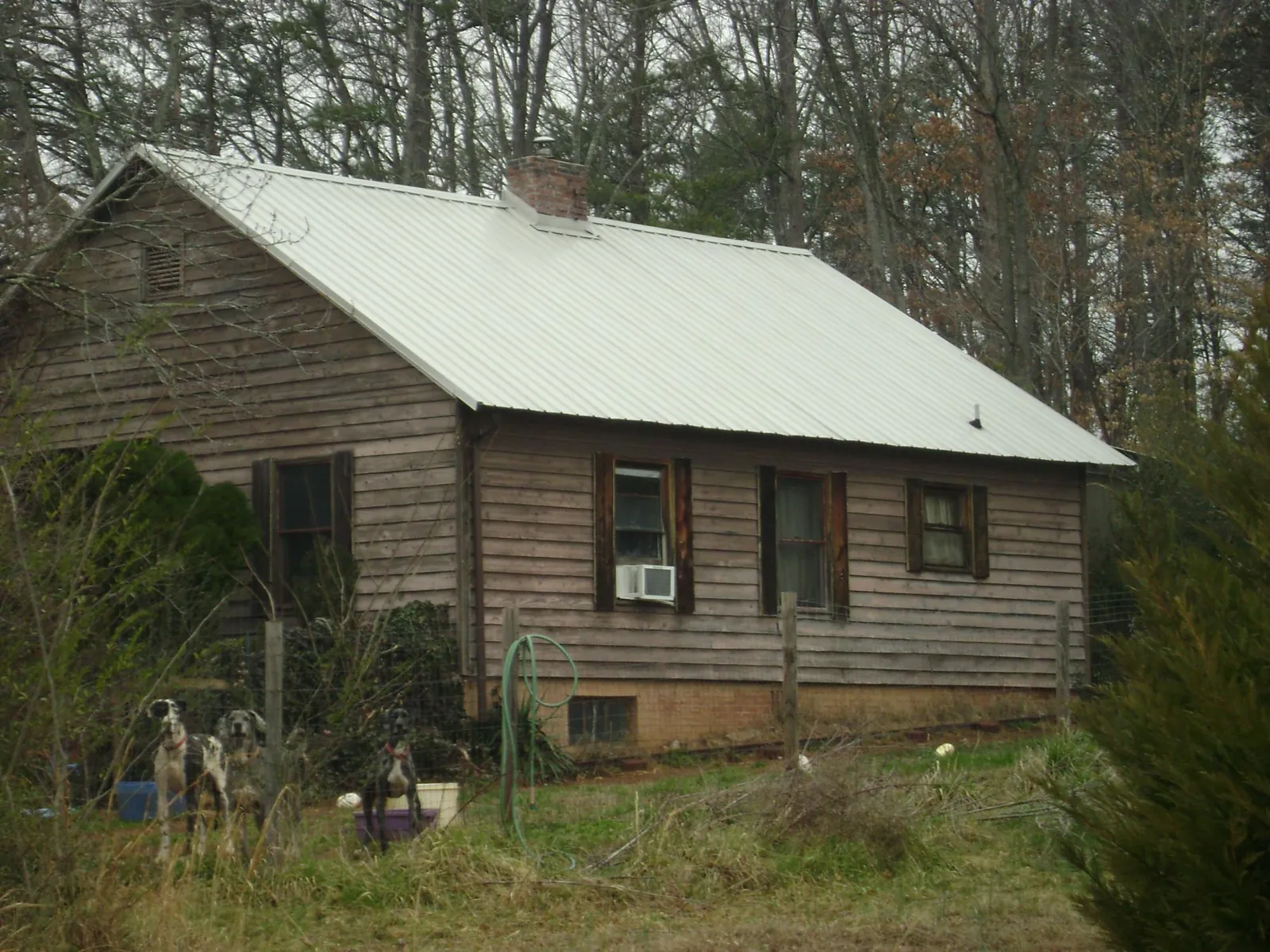 White metal roof on an old wood sided farmhouse, from a Asphalt Shingle Roof Repair job in Sykesville